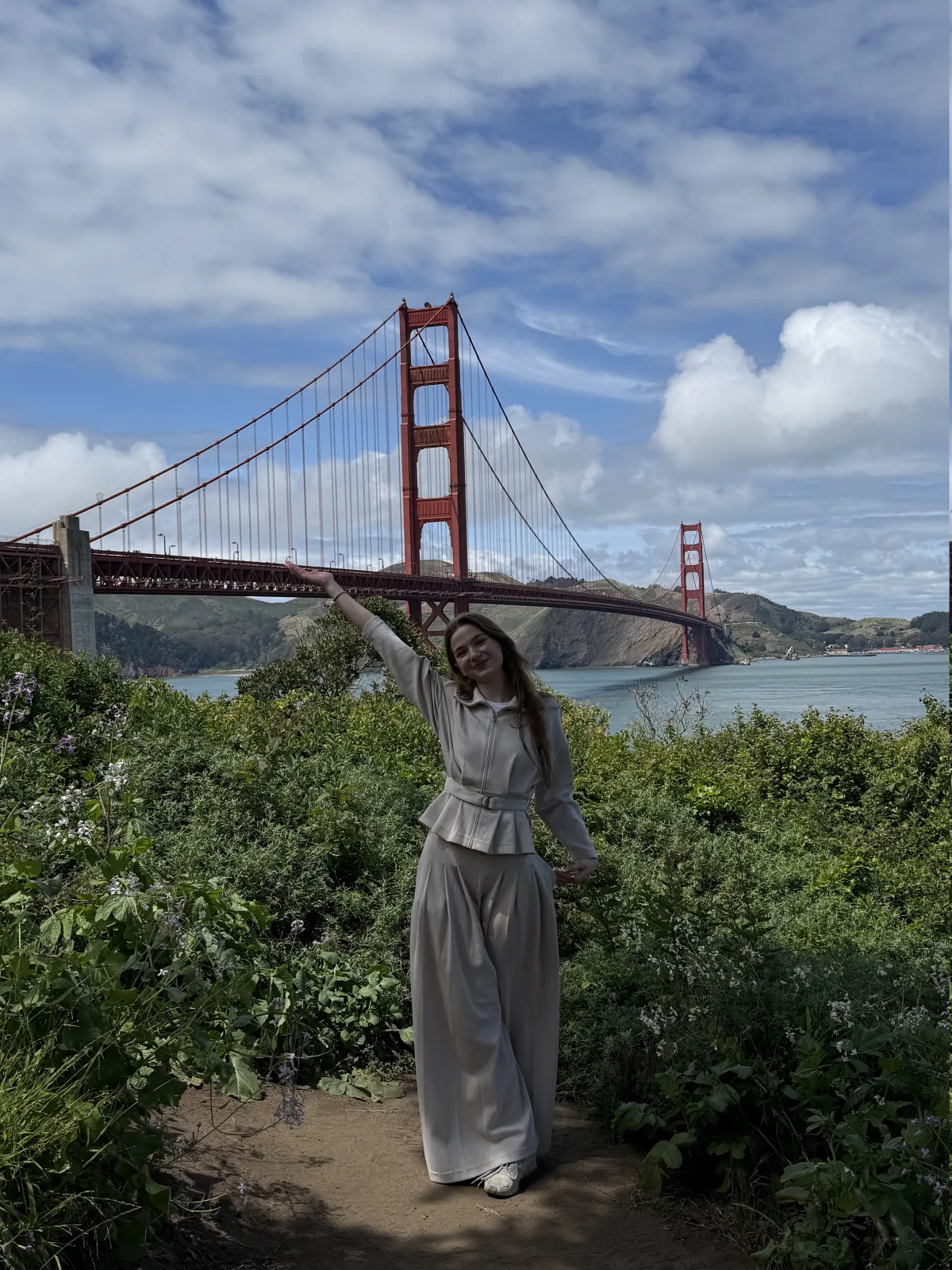 Goda standing near the Golden Gate Bridge in San Francisco